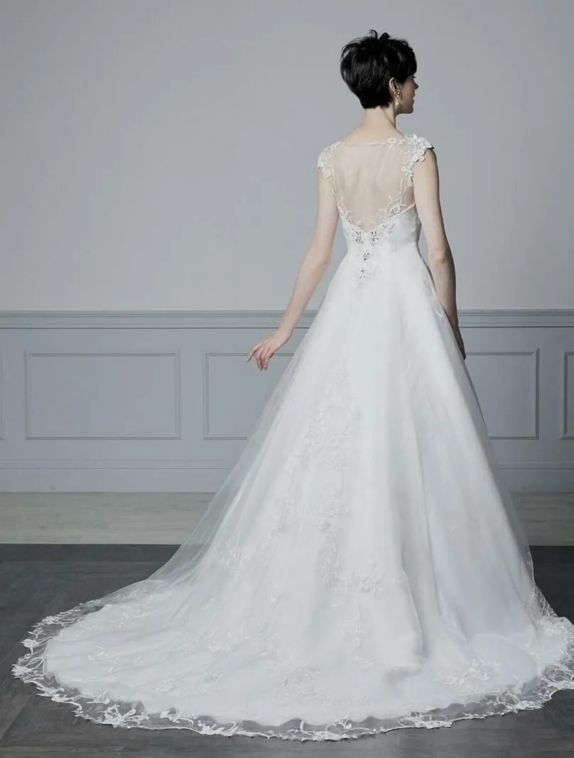---Elegant wedding dress with sheer bodice for a super sensual look made of satin and tulle with lace appliques and sparkling st